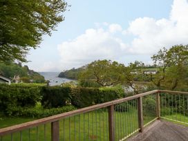 A view of water and trees from a balcony at The Meadow in Feock near Carnon Downs