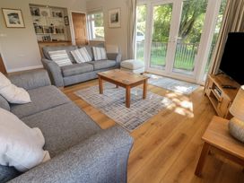 A living room with a sofa and coffee table at The Meadow in Feock near Carnon Downs