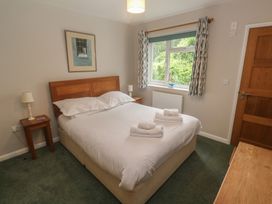 A bedroom with a bed and bedside table at The Meadow in Feock near Carnon Downs