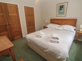 A bedroom with a bed and bedside tables at The Meadow in Feock near Carnon Downs