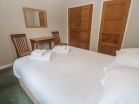 A bedroom with a bed and a small table with chairs at The Meadow in Feock near Carnon Downs