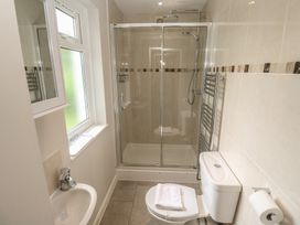 A bathroom with a shower, sink, and toilet at The Meadow in Feock near Carnon Downs