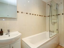 A bathroom with a bathtub and sink at The Meadow in Feock near Carnon Downs
