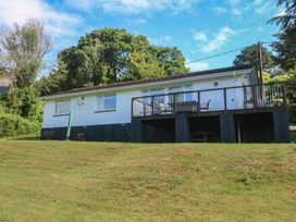 A house with a deck and chairs at The Meadow in Feock near Carnon Downs