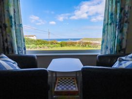 A living room with a view of the ocean at Pentreath in Crantock