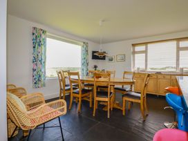 A dining room with a table and chairs at Pentreath in Crantock