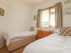A bedroom with two beds and a chest of drawers at Pentreath in Crantock