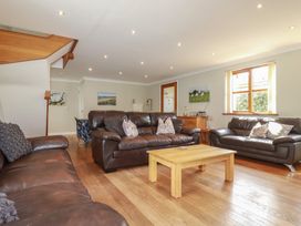 A living room with sofas and a coffee table at Carpe Diem in Crantock