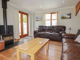 A living room with a sofa and coffee table at Carpe Diem in Crantock
