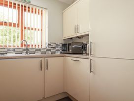 A kitchen with a sink and microwave at Carpe Diem in Crantock