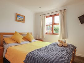A bedroom with a bed and window at Carpe Diem in Crantock