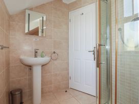 A bathroom with a sink and shower at Carpe Diem in Crantock