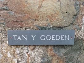 A sign for Tan Y Goeden on a stone wall at Tan Y Goeden in Morfa Nefyn