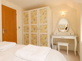 A bedroom with a wardrobe and dressing table at Tan Y Goeden in Morfa Nefyn