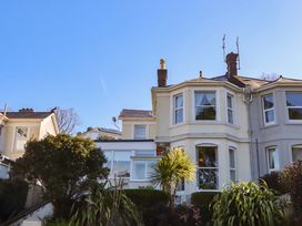 A house with several windows and plants at Avenue Park Villa in Torquay