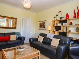 A living room with two sofas and a table at Avenue Park Villa in Torquay