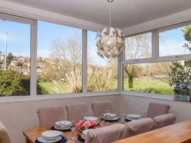 A dining room with a table set for dinner at Avenue Park Villa in Torquay