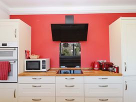 A kitchen with appliances and cabinets at Avenue Park Villa in Torquay