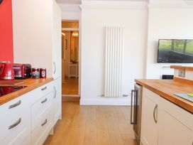 A kitchen with appliances and cabinetry at Avenue Park Villa in Torquay