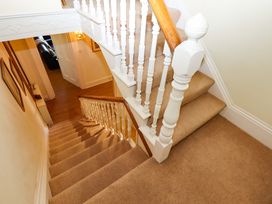 A staircase with a handrail at Avenue Park Villa in Torquay