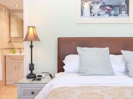 A bedroom with a bed and lamp at Avenue Park Villa in Torquay