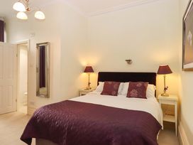 A bedroom with a bed and bedside tables at Avenue Park Villa in Torquay