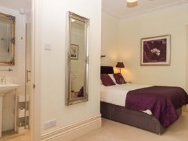 A bedroom with a bed and wash basin at Avenue Park Villa in Torquay