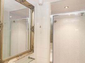 A bathroom with a shower and a mirror at Avenue Park Villa in Torquay