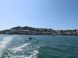 A view of boats and buildings on a shore at Avenue Park Villa in Torquay