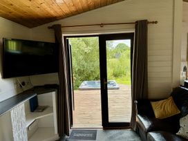 A living room with a television and sofa at Willow Lodge Constantine near Falmouth