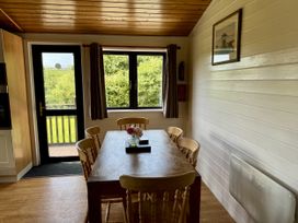 A kitchen with a table and chairs at Willow Lodge Constantine near Falmouth