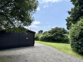 An outdoor area with a building and pathway at Willow Lodge in Constantine near Falmouth