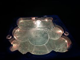 A hot tub with illuminated water at Willow Lodge Constantine near Falmouth