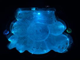 A hot tub with blue LED lights and water at Willow Lodge Constantine near Falmouth