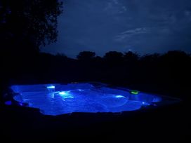 A hot tub with blue lighting in the evening at Willow Lodge Constantine near Falmouth