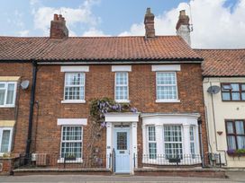 A house with a blue door and plants at Springfield in Hempton near Fakenham