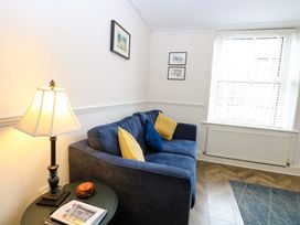A living room with a sofa and lamp at Springfield in Hempton near Fakenham