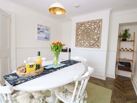 A dining room with a table and chairs at Springfield in Hempton near Fakenham