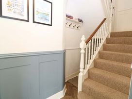 A staircase with a handrail in a hallway at Springfield in Hempton near Fakenham