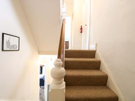 A staircase with handrail and wall art at Springfield in Hempton near Fakenham