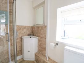A bathroom with a shower, sink, and toilet at Springfield in Hempton near Fakenham