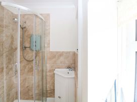 A bathroom with a shower and sink at Springfield in Hempton near Fakenham