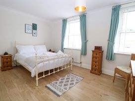 A bedroom with a bed, side tables, and a dresser at Springfield in Hempton near Fakenham