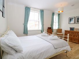 A bedroom with a bed and a dresser at Springfield in Hempton near Fakenham