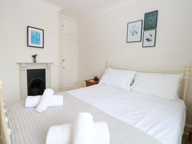 A bedroom with a bed and artwork on the wall at Springfield in Hempton near Fakenham