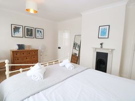 A bedroom with a bed and chest of drawers at Springfield in Hempton near Fakenham