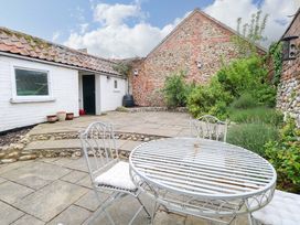A garden with a table and chairs at Springfield in Hempton near Fakenham