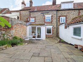 An outdoor area with a stone patio and seating at Springfield in Hempton near Fakenham