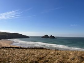 A view of beach and ocean with rocks at Holywell Bay View in Holywell Bay