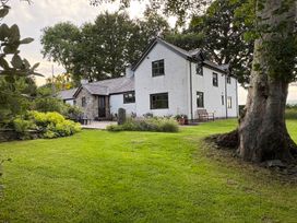 A house with a garden and tree at Garth Cottage in Groes near Denbigh